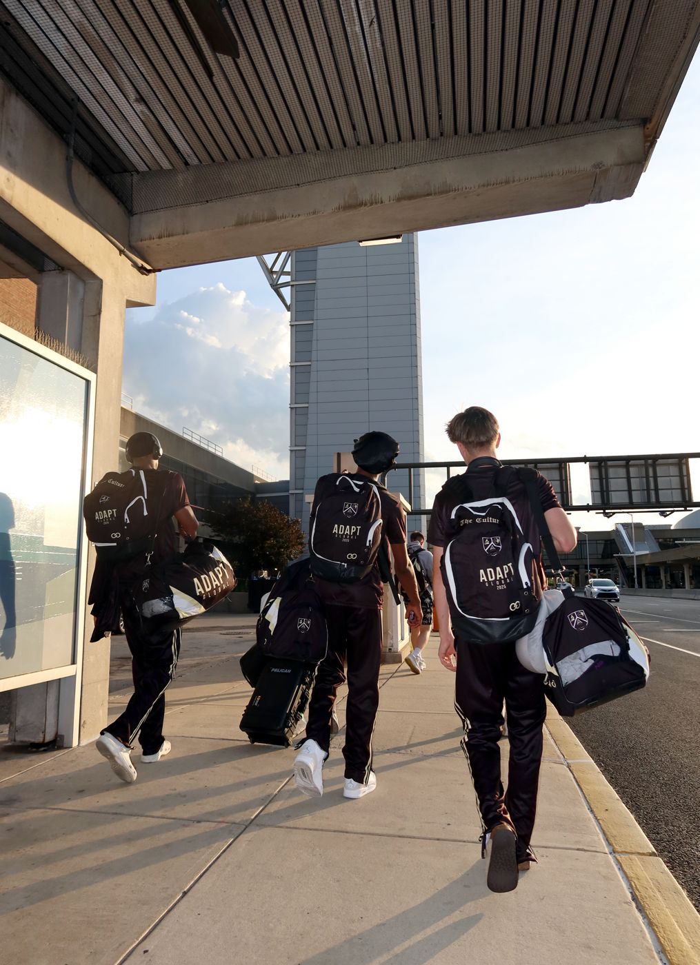 ADAPT Global players walking with matching backpacks and duffel bags