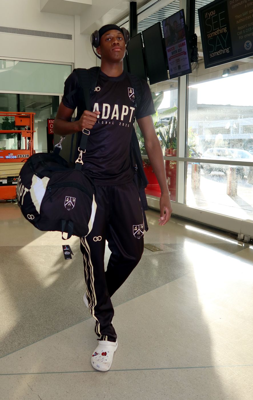 ADAPT player in a Wooter track suit carrying a matching duffel bag